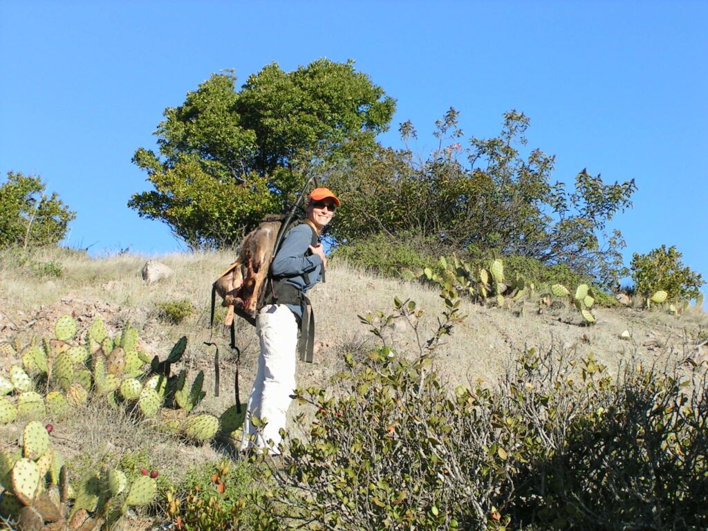 Former Conservancy Director of Conservation packing out a harvested deer on Catalina Island.