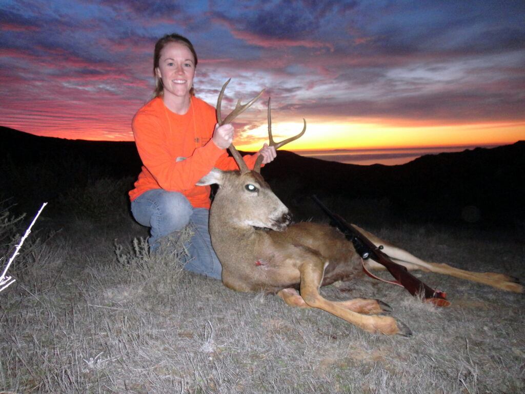 Former Conservancy Conservation Operations Coordinator and Botanist Amy Dvorak (Catalano) posing with a deer she harvested on Catalina Island.