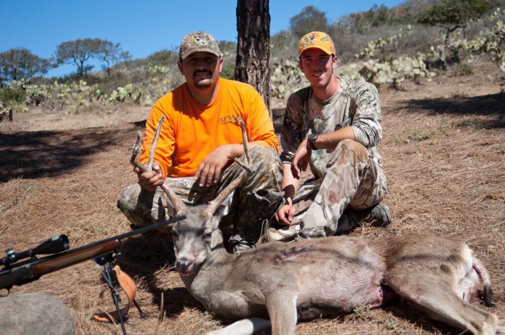 Conservancy hunting guide Tyler Dvorak posing with a visiting hunter on Catalina Island.