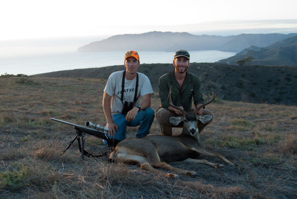 Former Conservancy Wildlife Biologist and Hunting Guide Tyler Dvorak posing with a visiting hunter on Catalina Island